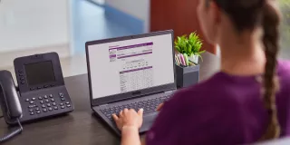 Nurse on computer looking at digital solutions