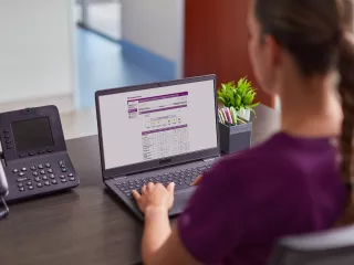 Nurse on computer looking at digital solutions
