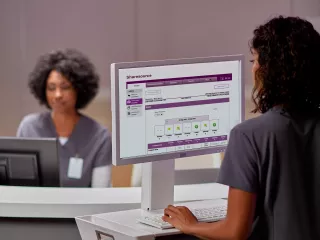 Woman on laptop viewing Sharesource remote patient management